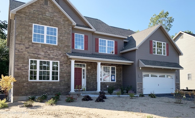 view of front of house with a garage, stone siding, and a shingled roof