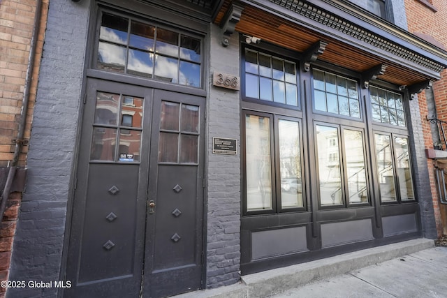 property entrance featuring brick siding