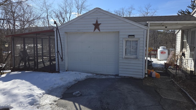 snow covered garage with a garage