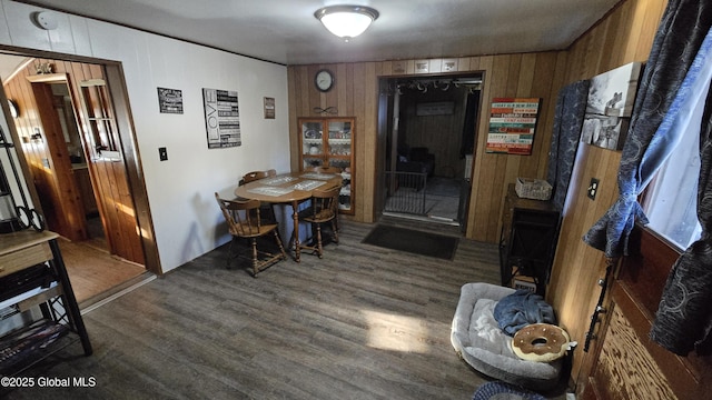 dining area with wood walls and wood finished floors