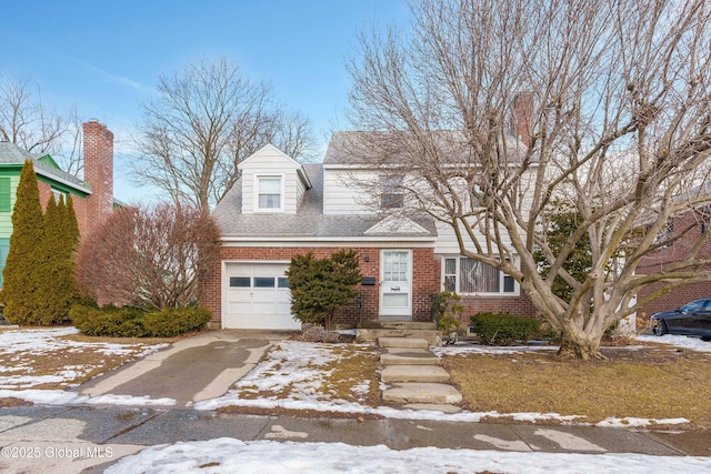 view of front facade with a garage, concrete driveway, brick siding, and roof with shingles