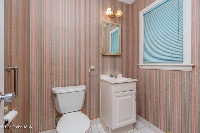 half bathroom featuring tile patterned flooring, toilet, and wallpapered walls