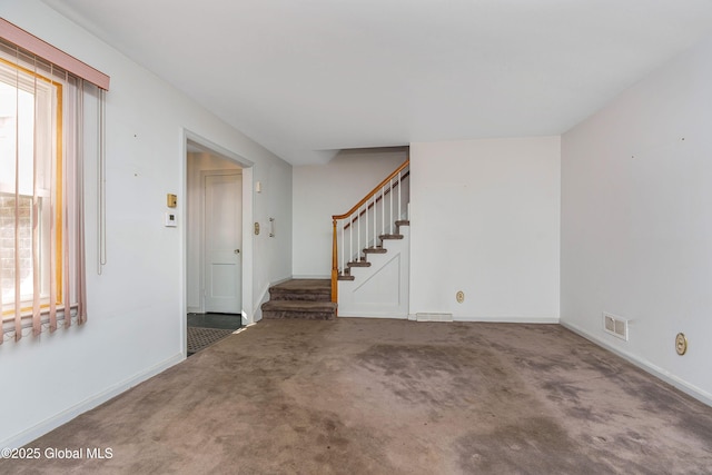 interior space with plenty of natural light, visible vents, stairway, and baseboards