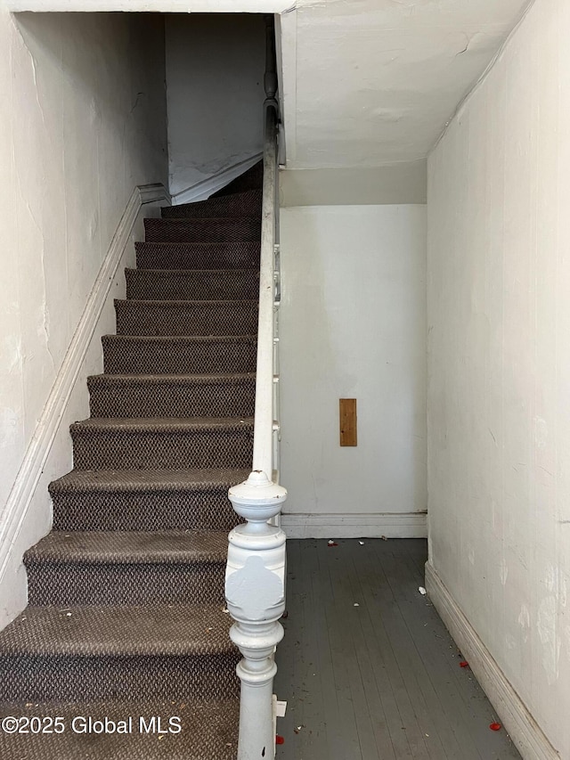 stairs featuring baseboards and hardwood / wood-style floors