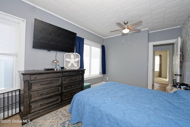 bedroom featuring a ceiling fan and ornamental molding