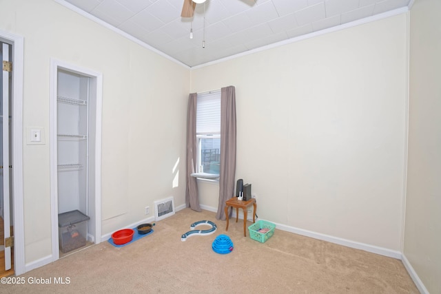 unfurnished bedroom featuring visible vents, carpet floors, baseboards, and ornamental molding