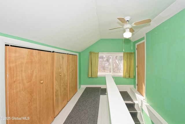 bonus room with ceiling fan, baseboards, and lofted ceiling