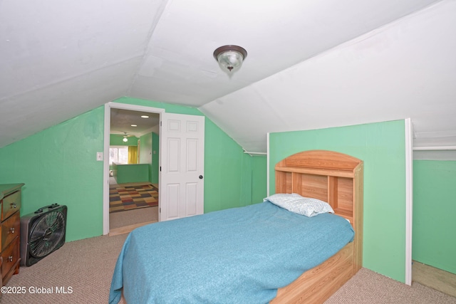 carpeted bedroom with lofted ceiling