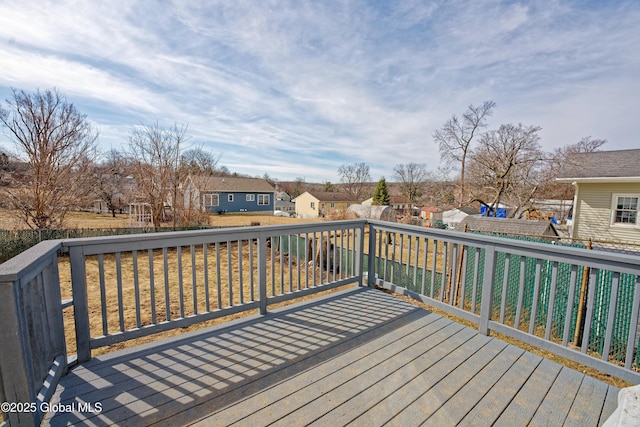 deck featuring a lawn and a residential view