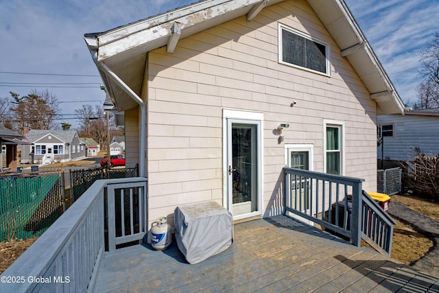 back of house featuring fence and a wooden deck