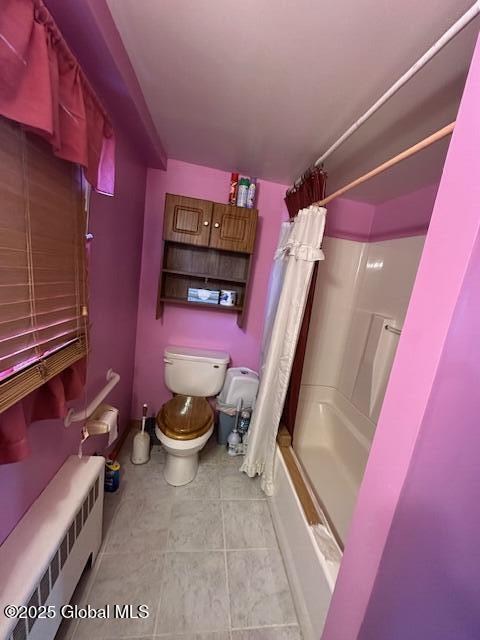 bathroom with toilet, radiator heating unit, tile patterned flooring, and shower / tub combo with curtain