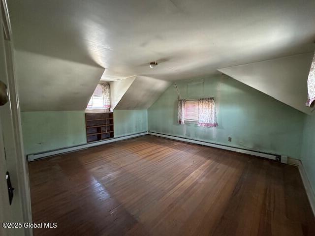 additional living space featuring vaulted ceiling and wood finished floors