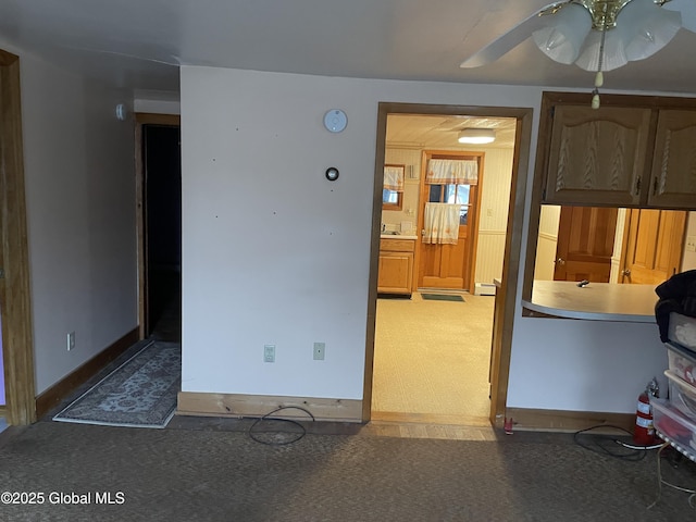 interior space featuring light carpet and baseboards