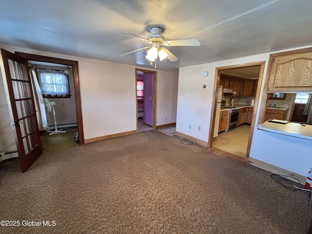 unfurnished living room with a baseboard heating unit, a ceiling fan, baseboards, and light carpet