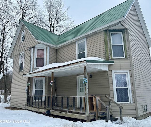 view of front of house featuring covered porch and metal roof