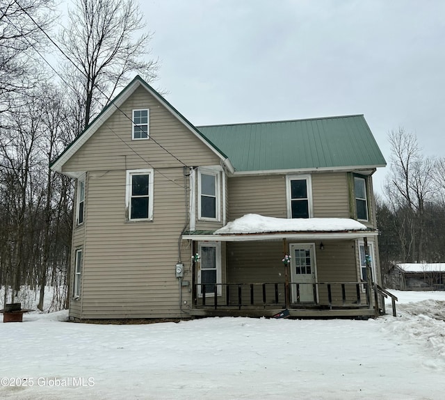 view of front facade with metal roof and a porch