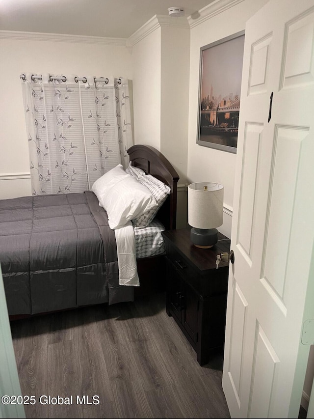 bedroom featuring dark wood-type flooring and crown molding