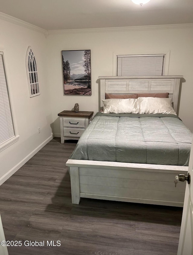 bedroom featuring baseboards, dark wood-type flooring, and crown molding