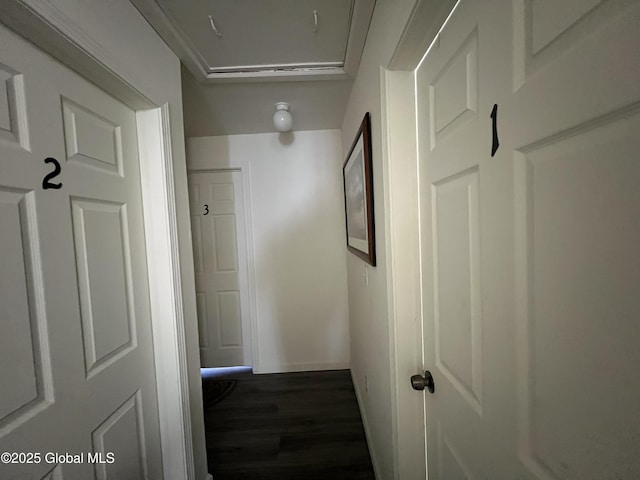 hall with wood finished floors and baseboards