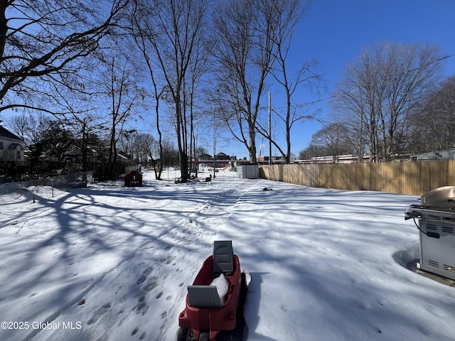 yard covered in snow with fence