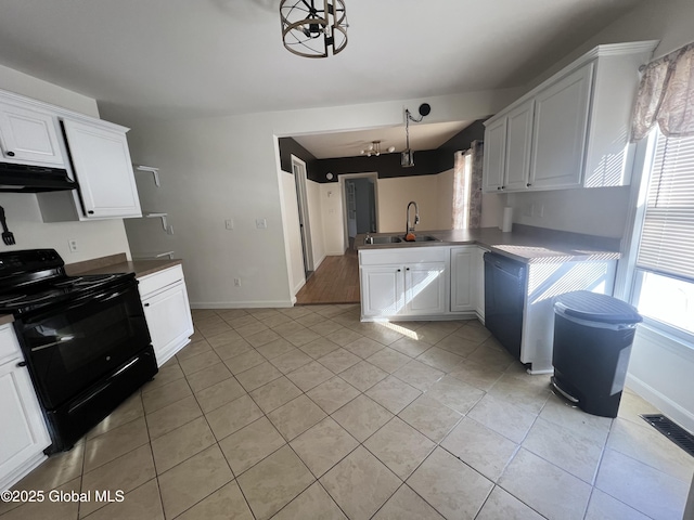 kitchen featuring white cabinetry, a sink, a peninsula, under cabinet range hood, and black / electric stove