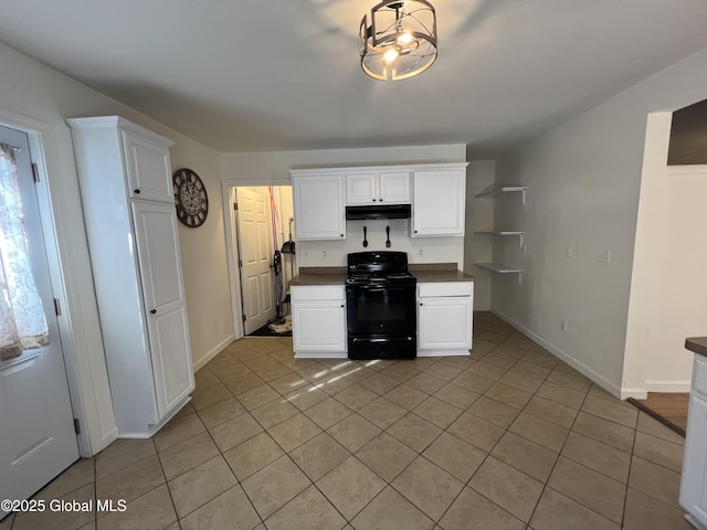 kitchen with black / electric stove, light tile patterned flooring, white cabinetry, and under cabinet range hood