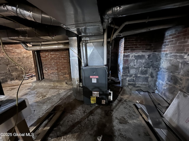 utility room featuring heating unit