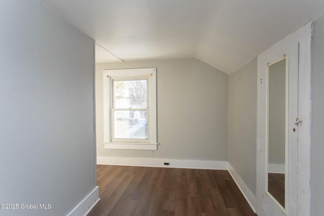 additional living space with vaulted ceiling, wood finished floors, and baseboards