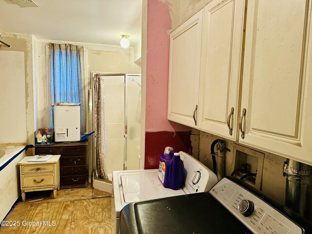 laundry room featuring laundry area, washer / dryer, and light wood-type flooring