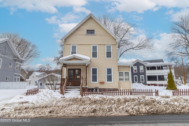 view of front of house featuring a fenced front yard and french doors