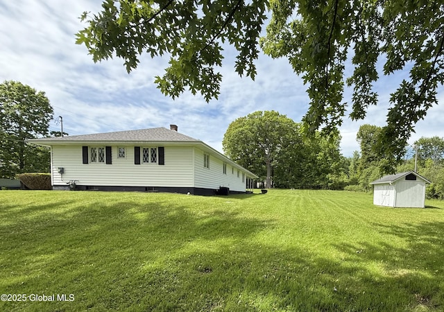 24 Regina Ln, Amsterdam, NY 12010 - view of side of home with a shed, a yard, and a chimney