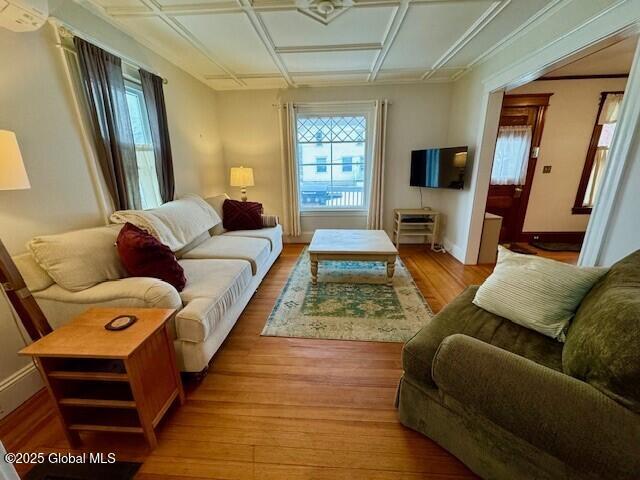 living room featuring baseboards and wood finished floors