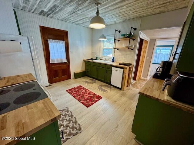 kitchen featuring light wood-style floors, white appliances, wooden counters, and green cabinets