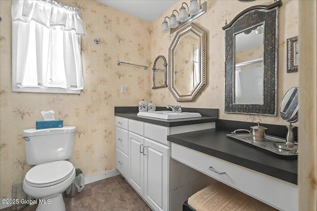 full bath featuring wallpapered walls, walk in shower, baseboards, toilet, and vanity