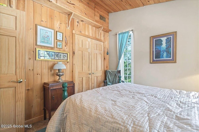 bedroom with a closet and wooden walls