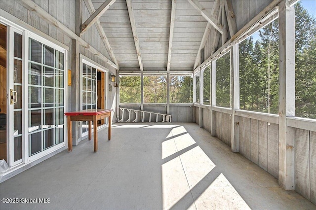 unfurnished sunroom with vaulted ceiling