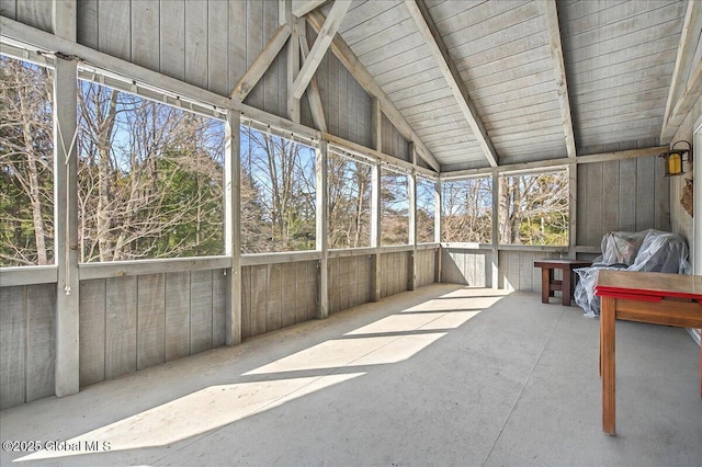 sunroom / solarium featuring vaulted ceiling