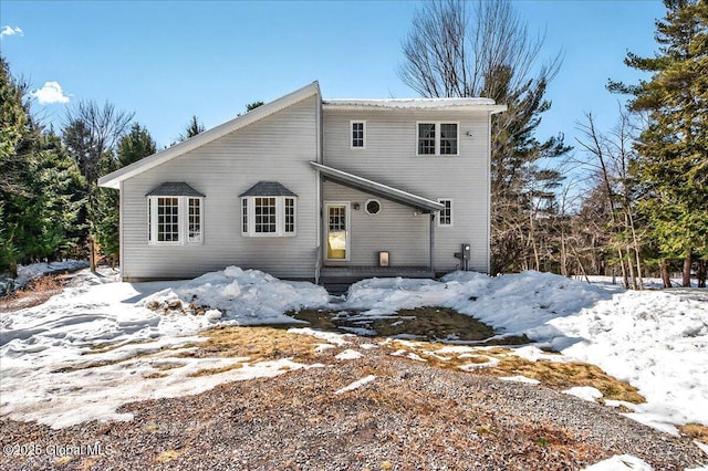 view of snow covered rear of property