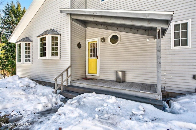 view of snow covered property entrance