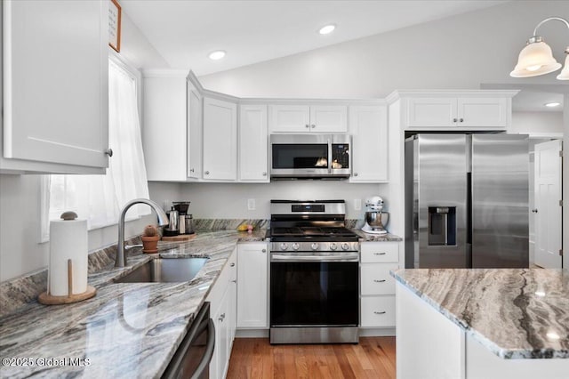 13 Alexander Way, Hudson Falls, NY 12839 - kitchen with stainless steel appliances, lofted ceiling, white cabinets, and a sink