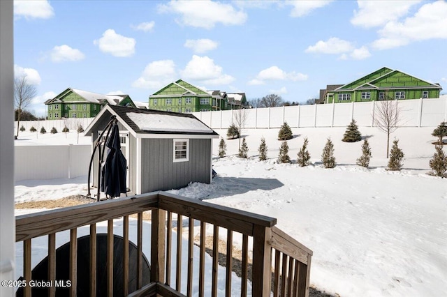 13 Alexander Way, Hudson Falls, NY 12839 - snowy yard featuring a fenced backyard, a storage unit, and an outdoor structure