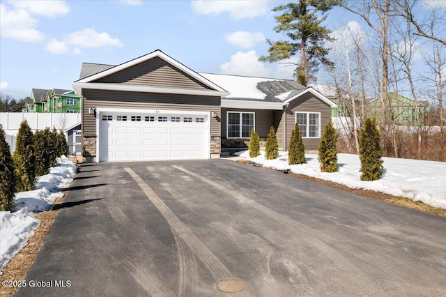 13 Alexander Way, Hudson Falls, NY 12839 - ranch-style house with aphalt driveway, stone siding, fence, and an attached garage