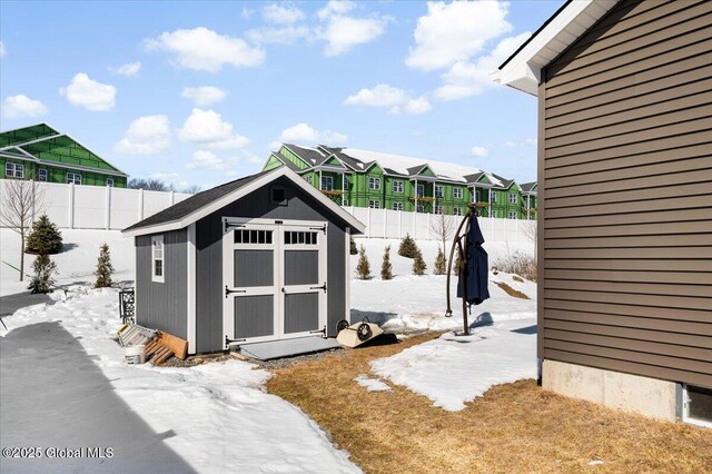 13 Alexander Way, Hudson Falls, NY 12839 - snow covered structure with a fenced backyard, a residential view, a storage unit, and an outdoor structure