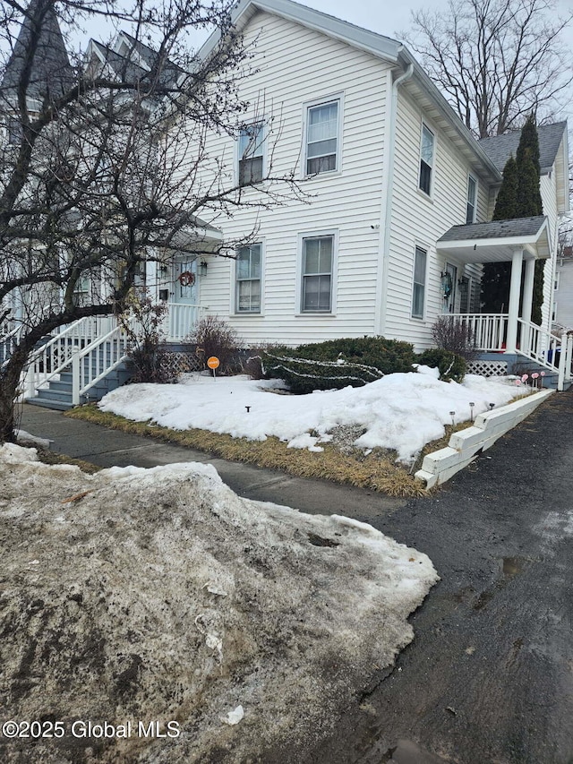 view of snow covered exterior with a porch