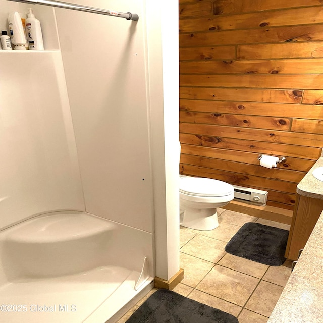 bathroom featuring toilet, wood walls, tile patterned flooring, and vanity