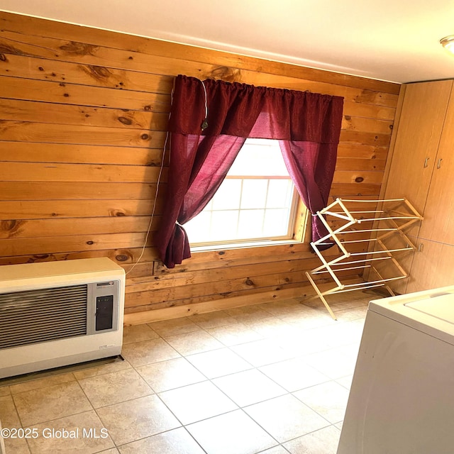 interior space featuring washer / clothes dryer, heating unit, and wooden walls