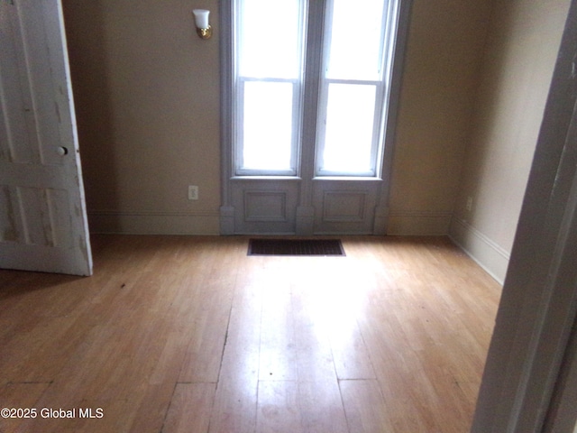 unfurnished room featuring light wood-style floors and baseboards