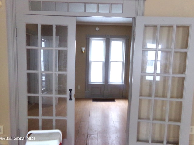 doorway to outside with french doors and wood finished floors