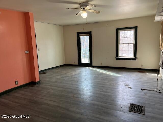 spare room with ceiling fan, baseboards, and wood finished floors