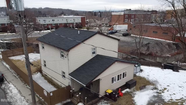 snowy aerial view with a residential view